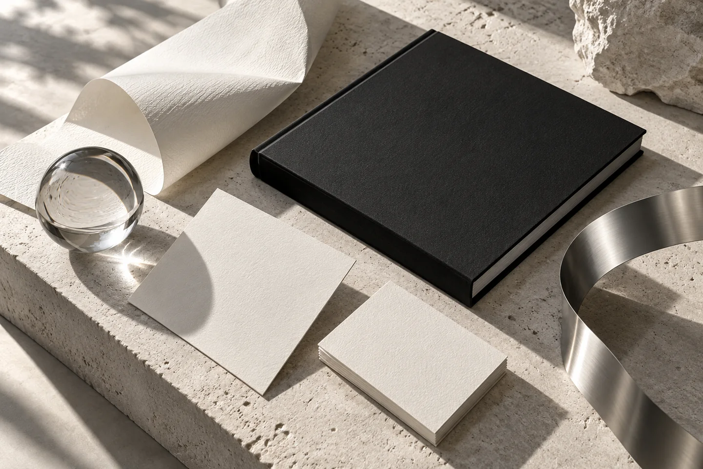 Blank stationery, textured paper and chrome sculpture in a brand design concept
